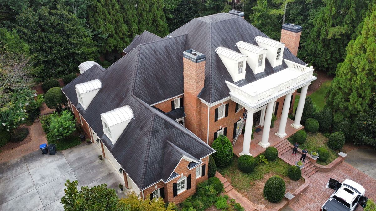 Left corner drone view of aging roof before replacement with Landmark Pro shingles