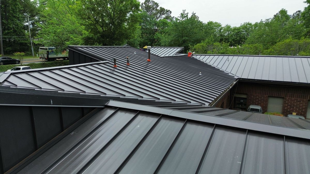 Commercial metal building with completed roof replacement — drone documentation of finished work