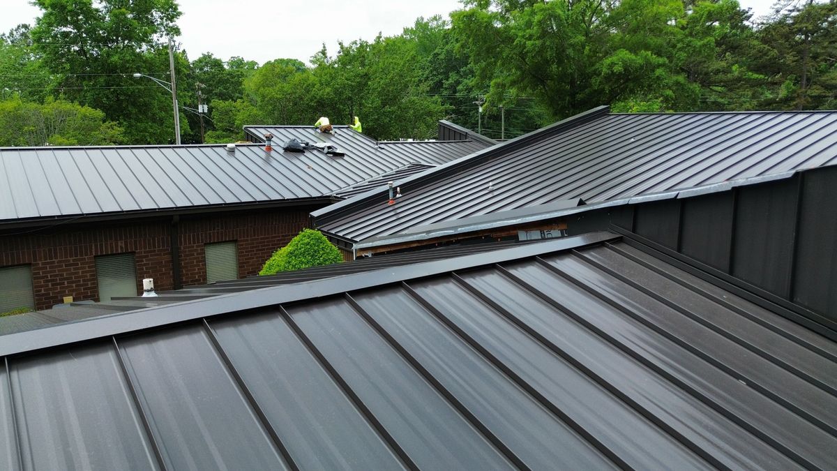 Aerial view of new commercial metal roof — clean installation with sealed flashings