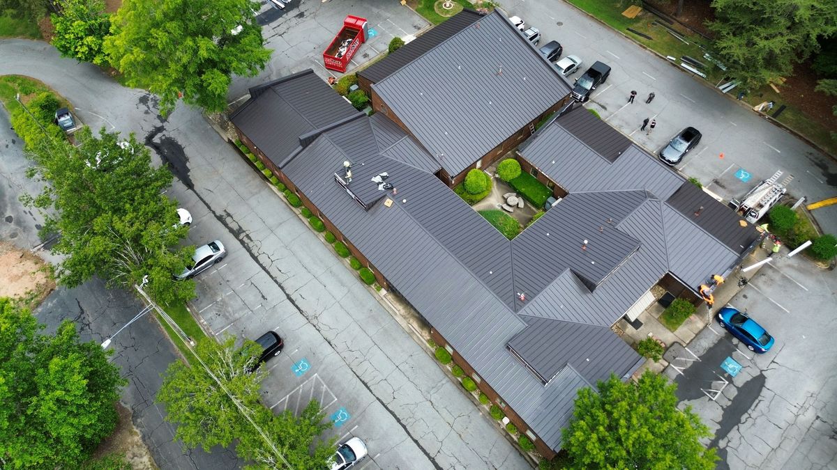 Completed commercial metal roof replacement — aerial drone overview of finished project