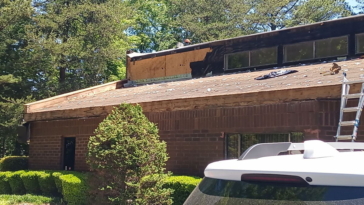 Commercial metal roof during installation — substrate preparation and new panel staging
