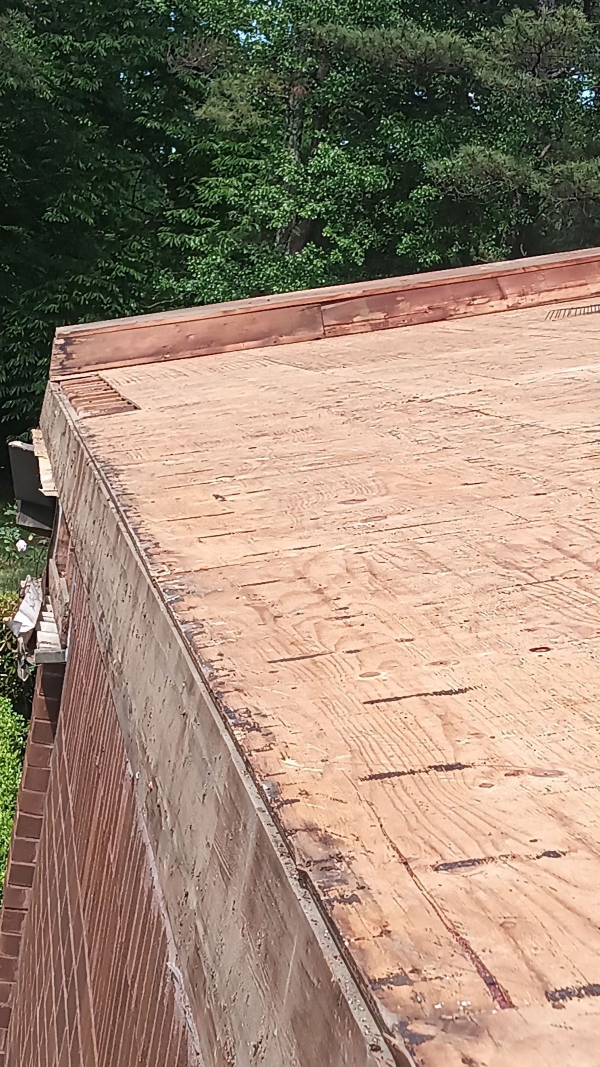 Commercial metal building roof replacement during tear-off and new panel installation phase