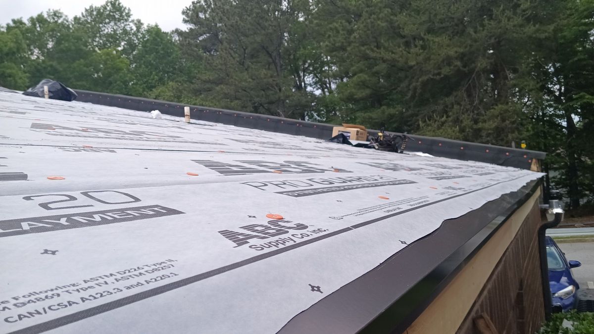 Drone documentation of commercial roof replacement — installation progress across full building
