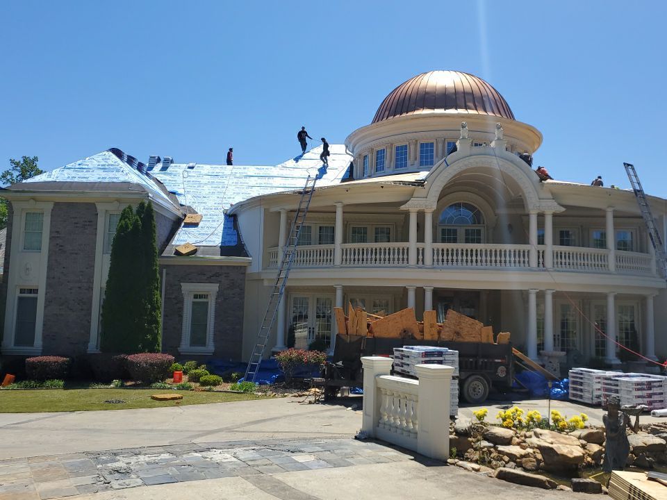 GAF HDZ Mission Brown shingles being installed on luxury estate roof section